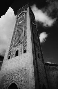 Low angle view of tower against cloudy sky