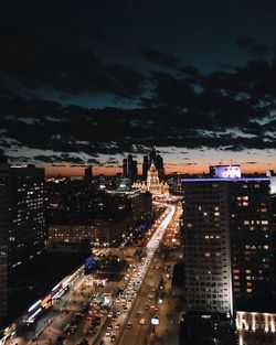 High angle view of illuminated city buildings at night