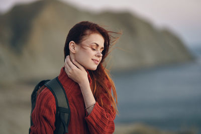 Young woman looking away outdoors