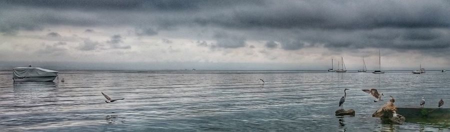 Scenic view of sea against cloudy sky