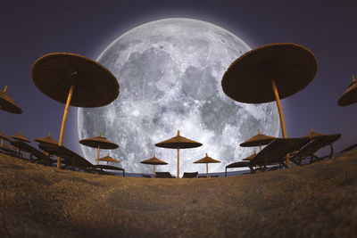 Low angle view of parasols against sky at night
