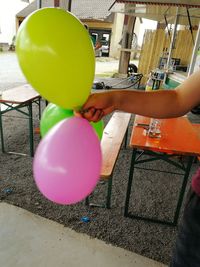 Person holding balloons