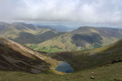 Scenic view of mountains against cloudy sky