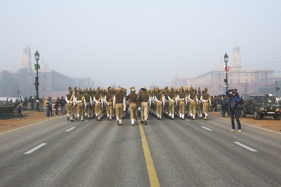 Panoramic view of people on road against clear sky