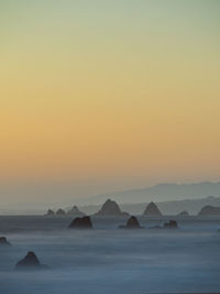 Scenic view of sea against clear sky during sunset