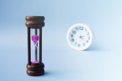 Close-up of alarm clock against blue background