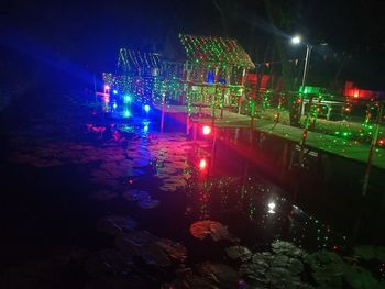 High angle view of illuminated ferris wheel at night