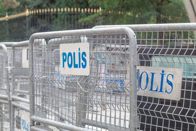 Close-up of warning sign on railing