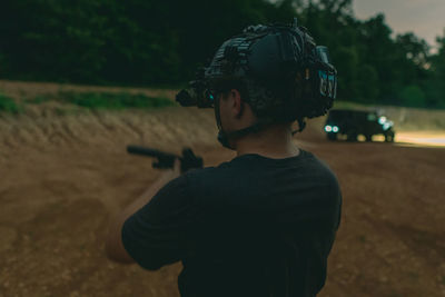 Rear view of boy standing on land
