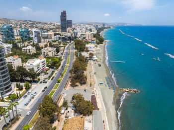 High angle view of city by sea against sky