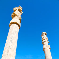 Low angle view of statue against blue sky