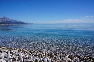 Scenic view of sea against clear blue sky