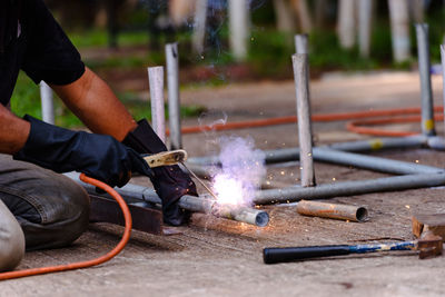 Midsection of worker welding metal