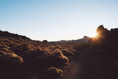 Scenic view of mountains against clear sky during sunset