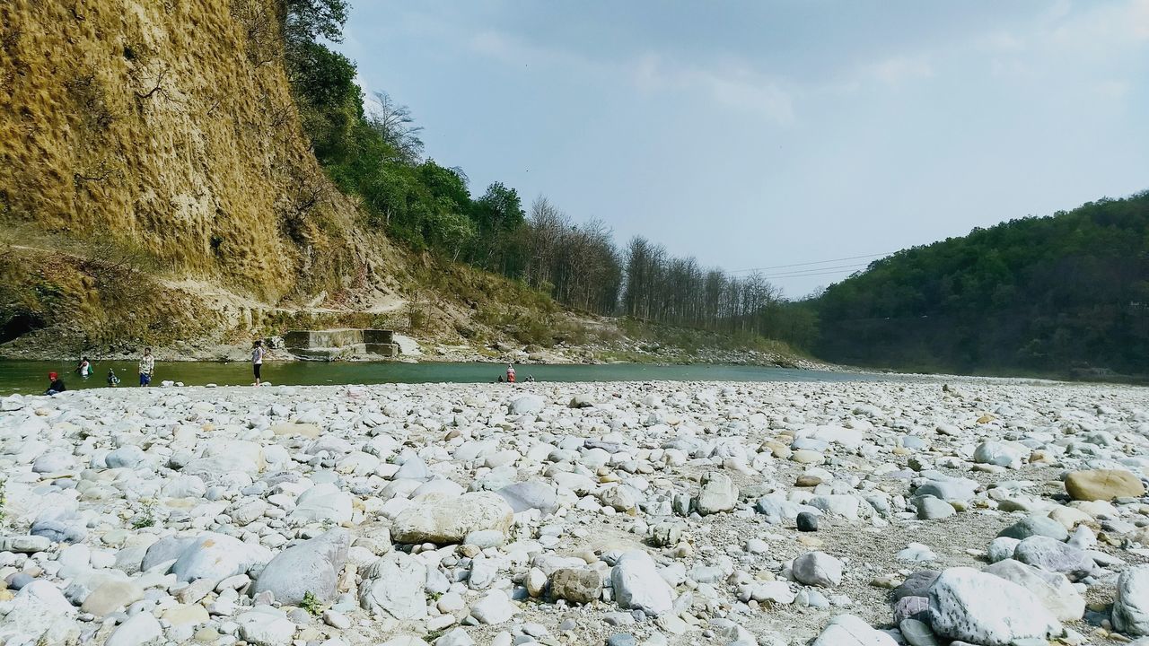 rock, solid, rock - object, beauty in nature, scenics - nature, day, nature, sky, tranquil scene, water, tranquility, mountain, tree, plant, no people, non-urban scene, transportation, land, environment, outdoors, surface level, track, pebble