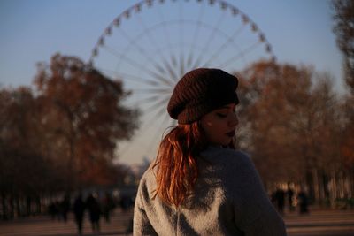 Woman looking over shoulder in city