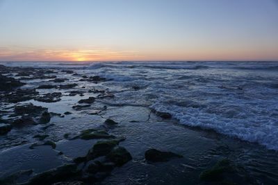 Scenic view of sea against clear sky during sunset