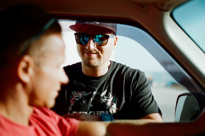 Close-up of young couple in car