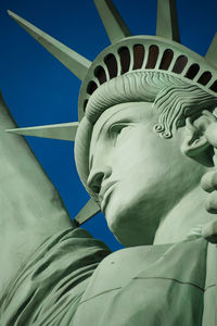 Low angle view of statue against blue sky