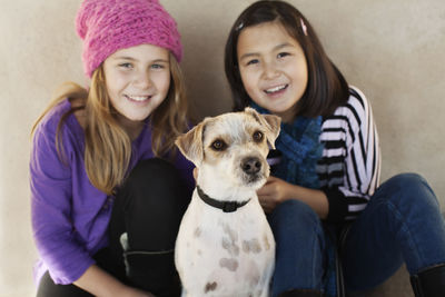 Portrait of two girls with dog