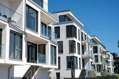 Low angle view of buildings against blue sky