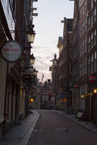 Street amidst buildings against sky in city