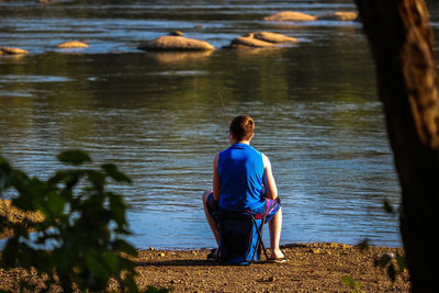 Rear view of woman looking at lake