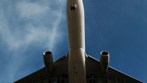 Low angle view of airplane against sky