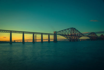 Bridge over river against blue sky