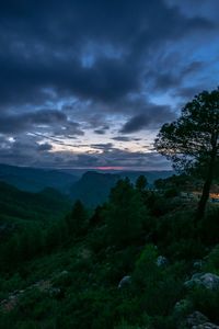 Scenic view of landscape against sky at dusk