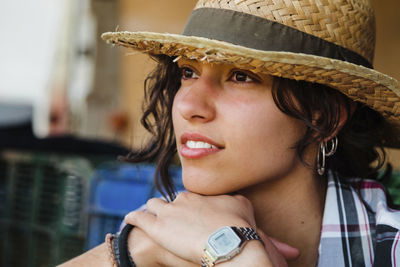 Portrait of beautiful young woman looking away