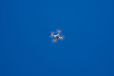 Low angle view of airshow against clear blue sky