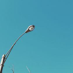 Low angle view of street light against clear blue sky