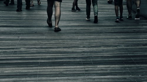 Low section of people walking on zebra crossing