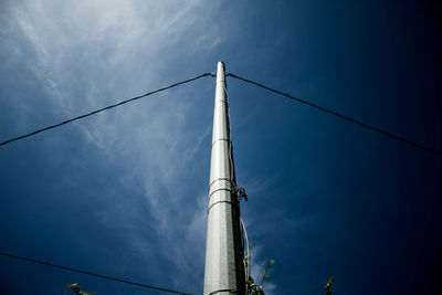 Low angle view of telephone pole against sky