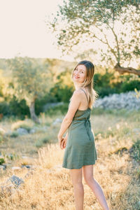 Young woman standing on field