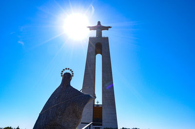 Low angle view of statue against blue sky