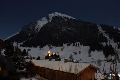 Scenic view of snow covered mountain at night