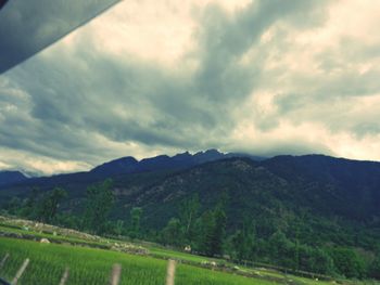 Scenic view of landscape against cloudy sky