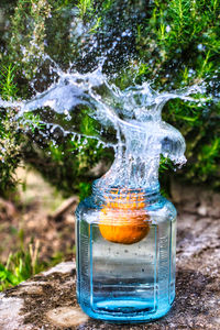 Close-up of water splashing in glass