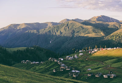 High angle view of field and buildings against sky