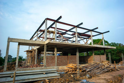 Low angle view of old construction site against sky