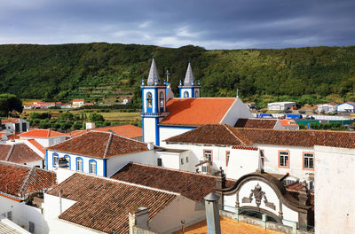 Houses in town against sky