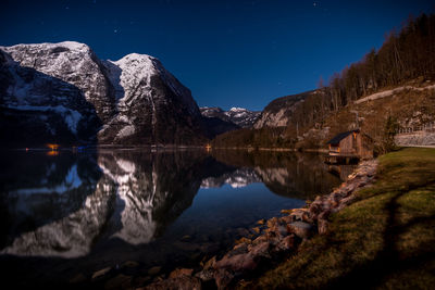 Scenic view of lake against sky at night