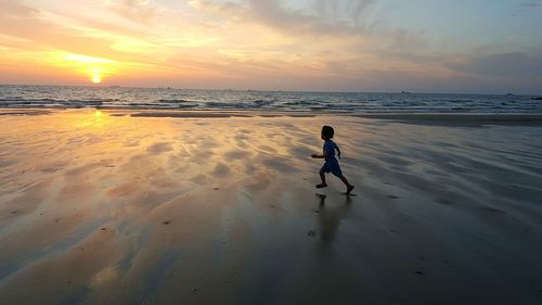 People on beach at sunset