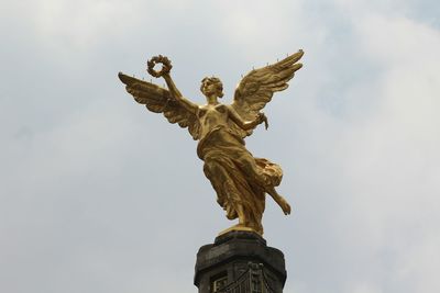 Low angle view of statue against cloudy sky