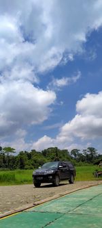 Car on field against sky