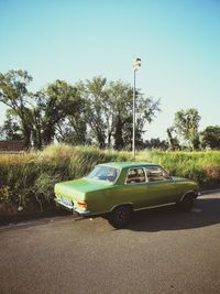 Car on road against clear blue sky