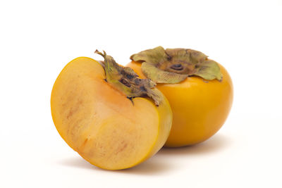 Close-up of orange fruit against white background