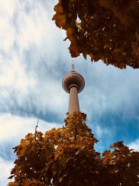 Low angle view of communications tower against sky